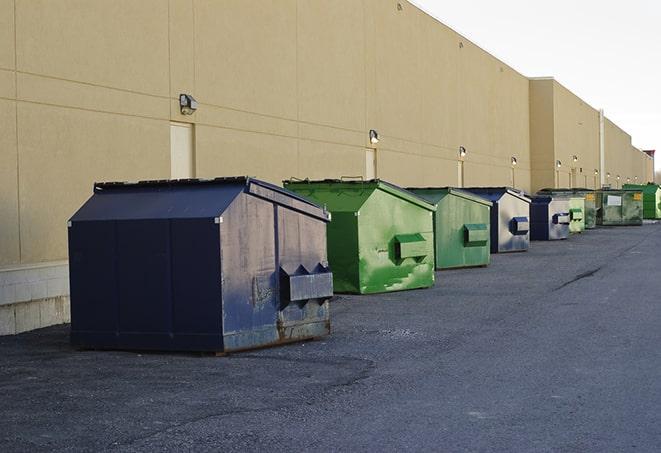 a fleet of red and blue construction dumpsters available for use in Somers